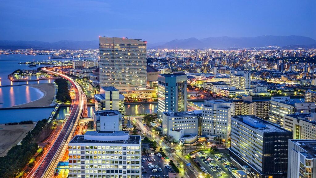 Fukuoka skyline with modern architecture and traditional temples at sunset